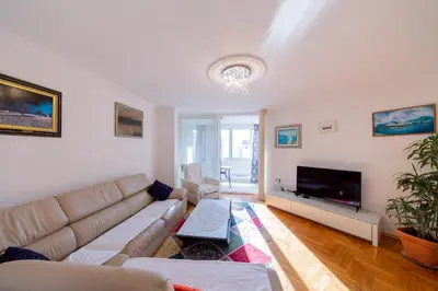 a living room with a couch and a tv at Apartment Sambra in Budva