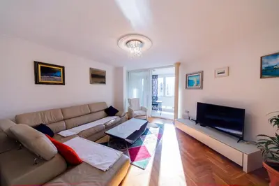 a living room with a couch and a flat screen tv at Apartment Sambra in Budva