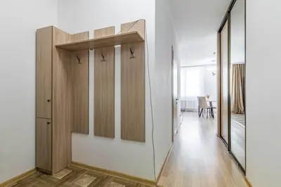 a room with white walls and wooden cabinets at Lipovina Anres Apartment in Petrovac na Moru