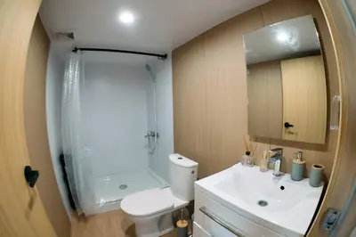 a bathroom with a toilet and a shower and a sink at GO Glamping in Dobra Voda