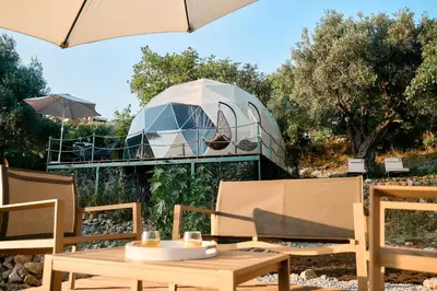 a table and chairs with a tent in the background at GO Glamping in Dobra Voda