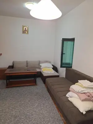 a living room with a couch and a coffee table at Start over in Budva