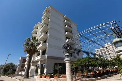 a tall building with a roller coaster around it at Alex apartment Bar in Bar