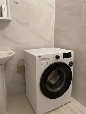 a white washing machine in a bathroom with a sink at Sea House E&F in Ulcinj