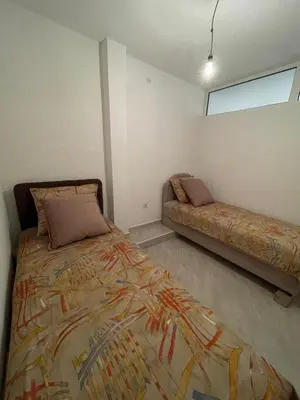 a bedroom with a bed and a couch in it at Sea House E&F in Ulcinj
