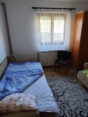 a bedroom with a bed and a couch and a television at Kaludjerovic in Cetinje