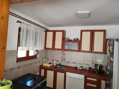a kitchen with wooden cabinets and a counter top at Kaludjerovic in Cetinje