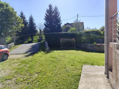 a yard with a gate in the grass at Kaludjerovic in Cetinje
