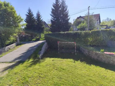 a gate in the grass next to a road at Kaludjerovic in Cetinje