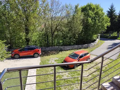 two cars parked next to each other in a parking lot at Kaludjerovic in Cetinje
