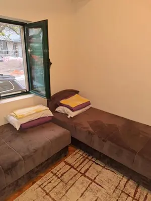 a room with two ottomans in front of a window at Start over in Budva