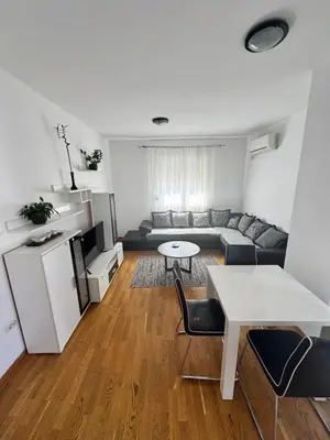 a living room with a couch and a table at Nema 2 in Kravlja