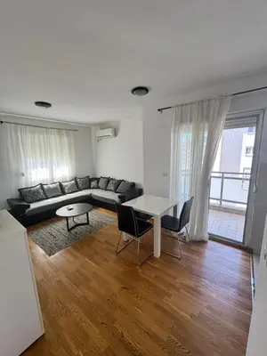 a living room with a couch and a table at City Apartment in Podgorica