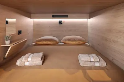 a bed in a room with two pillows on it at U-NIGHT Hostel Budva in Budva