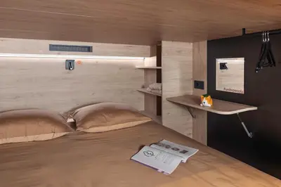 a bedroom with a bed with a book on it at U-NIGHT Hostel Budva in Budva