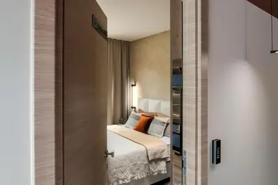 a small bedroom with a bed and a book shelf at U-NIGHT Hostel Budva in Budva