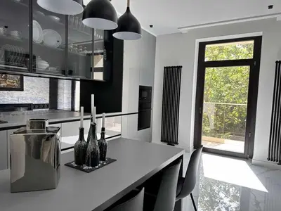 a kitchen with a counter with wine bottles on it at Apartments Silversany in Budva