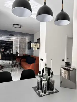 a living room with a table with vases on it at Apartments Silversany in Budva