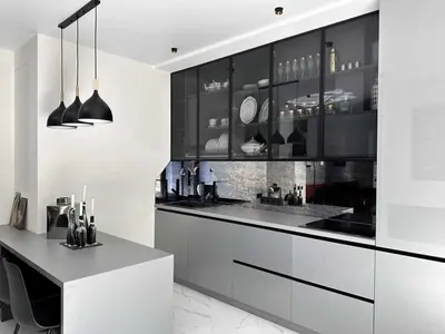 a kitchen with black and white cabinets and a counter at Apartments Silversany in Budva