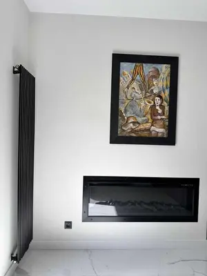 a fireplace in a room with a painting on the wall at Apartments Silversany in Budva