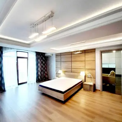 a bedroom with a bed in a room with wooden floors at Apartments Jimasly in Budva