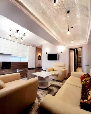 a living room with couches and a tv and a table at Apartments Jimasly in Budva