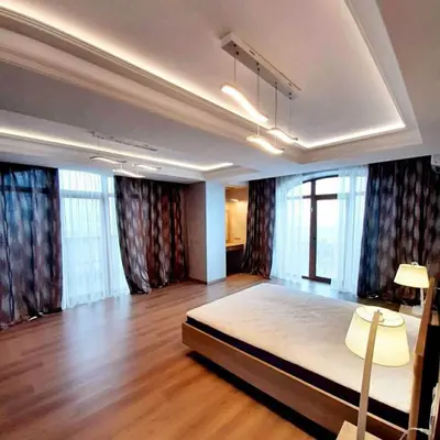 a bedroom with a large bed in a room with windows at Apartments Jimasly in Budva