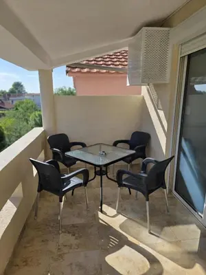 a patio with chairs and a table on a balcony at SHARRI Apartments in Ulcinj