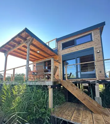 a house on a wooden deck with a view at Era Cottage in Ulcinj