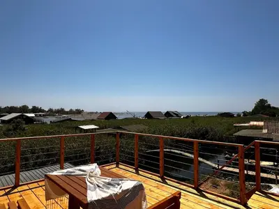 a wooden deck with a table on top of it at Era Cottage in Ulcinj