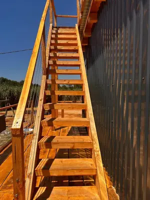 a wooden staircase leading up to a building at Era Cottage in Ulcinj