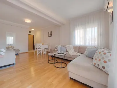 a living room with a couch and a table at Tucked in 2br apt with terrace in Budva in Budva