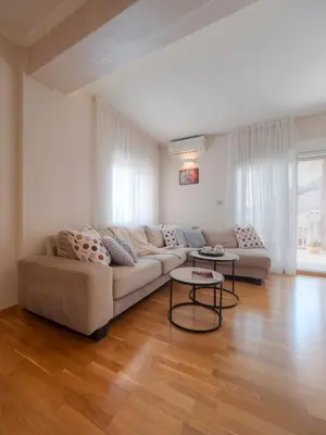 a living room with a couch and a table at Tucked in 2br apt with terrace in Budva in Budva