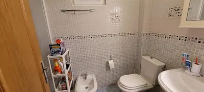 a small bathroom with a toilet and a sink at Аппартаменты Магнолия in Petrovac na Moru
