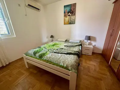 a bedroom with a large bed in a room at Аппартаменты Магнолия in Petrovac na Moru