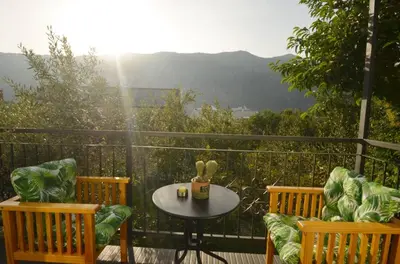 a table and chairs on a balcony with a view at Apartments Spasoje in Kotor