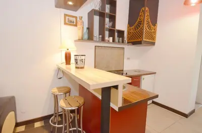 a kitchen with a counter and two stools at Apartments Spasoje in Kotor