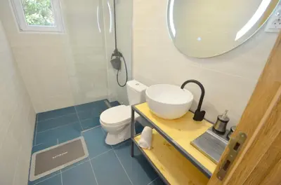 a bathroom with a sink and a toilet and a mirror at Apartments Spasoje in Kotor