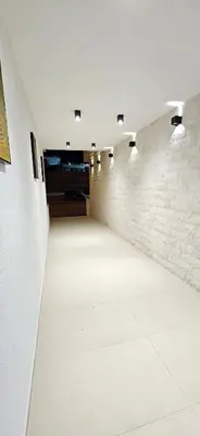an empty room with lights on a brick wall at Bahr DELUX App & Suite in Ulcinj