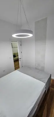a bedroom with a large white bed in a room at Bahr DELUX App & Suite in Ulcinj