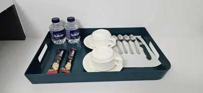 a tray with bottles of water and utensils at Bahr DELUX App & Suite in Ulcinj