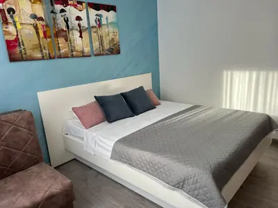 a bedroom with a bed with two pillows on it at Budva APT in Budva