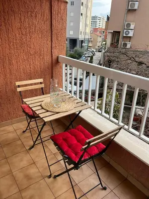 a table and two chairs on a balcony at Budva APT in Budva