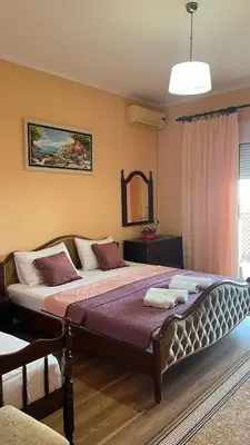 a bedroom with a large bed in a room at Golden Sun Apartment 2 in Ulcinj
