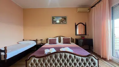 a bedroom with two beds and a window at Golden Sun Apartment 2 in Ulcinj