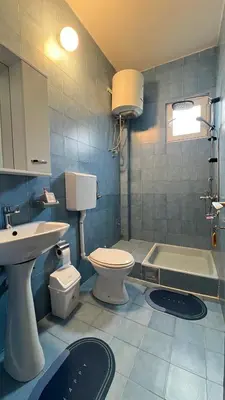 a bathroom with a toilet and a sink and a tub at Golden Sun Apartment 2 in Ulcinj
