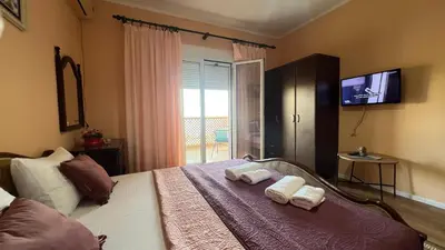 a bedroom with a bed with two towels on it at Golden Sun Apartment 2 in Ulcinj