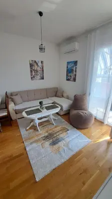 a living room with a couch and a coffee table at Blue wave apartman in Becici