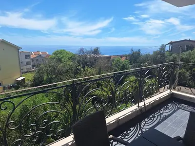 a balcony with a view of the ocean at Apartment Alma in Kravlja