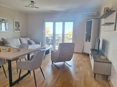 a living room with a table and a couch at Apartment Alma in Kravlja